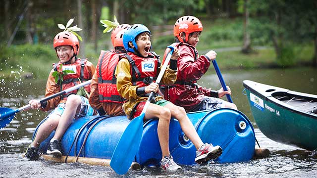 Activities - Children raft building on a lake at PGL